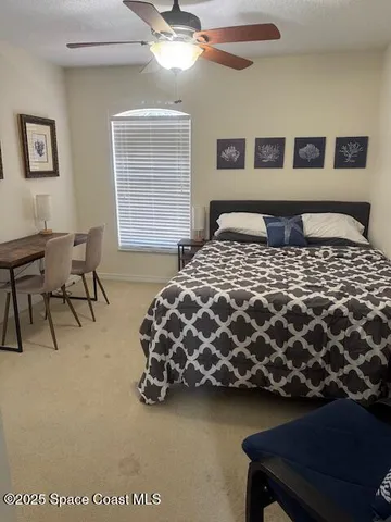 a bedroom with a bed and lamp with window