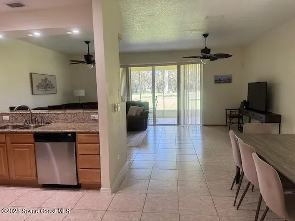 a kitchen with stainless steel appliances granite countertop a stove refrigerator and microwave