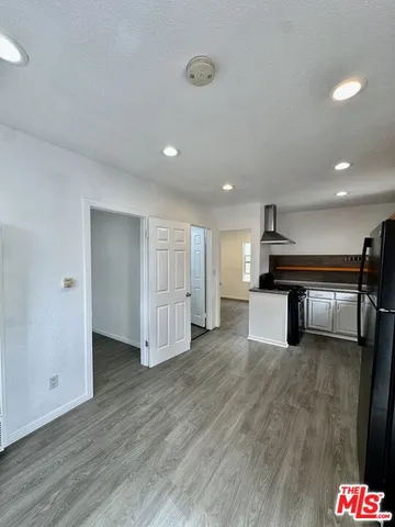 a view of a hall with wooden floor