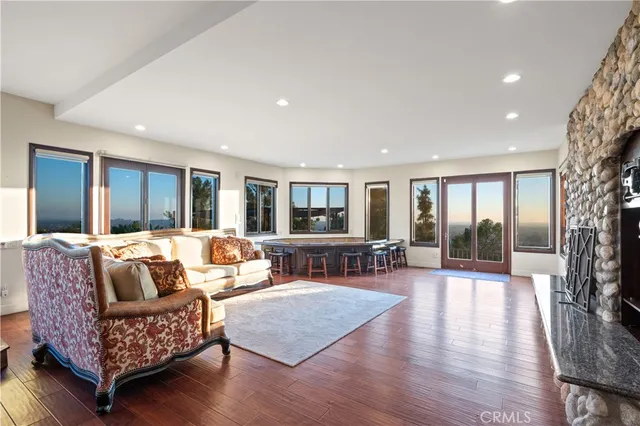 a living room with stainless steel appliances furniture and a kitchen view