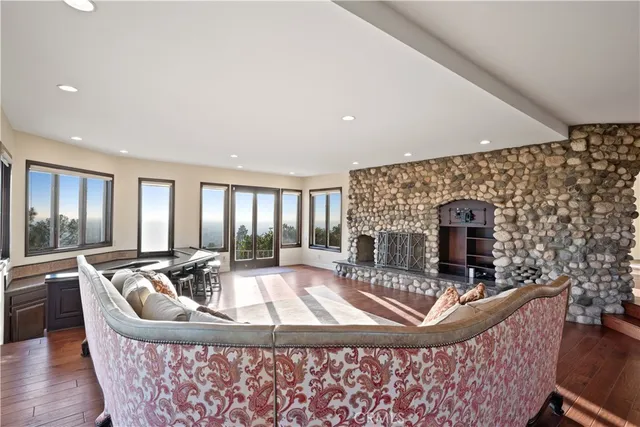a view of a livingroom with wooden floor and a window