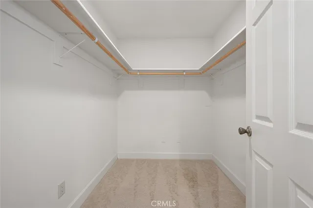 a view of an empty room with a window and a ceiling fan