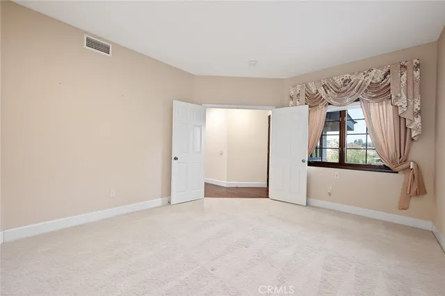 a spacious bathroom with a granite countertop double vanity sink and a mirror