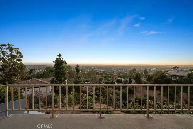 a view of a swimming pool and trees in the background