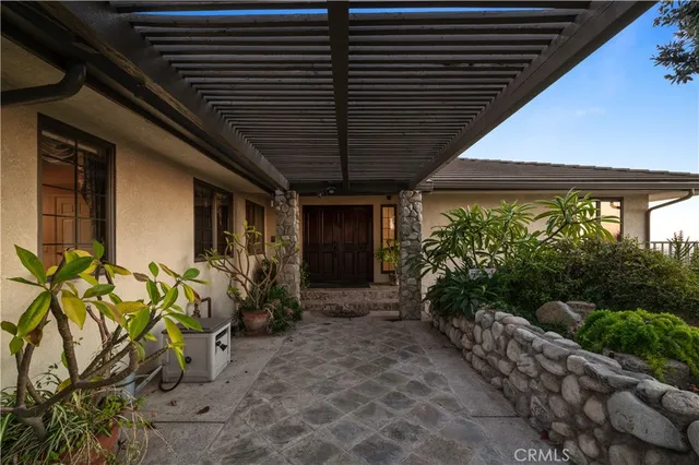 a view of a hallway with wooden floor and a chandelier
