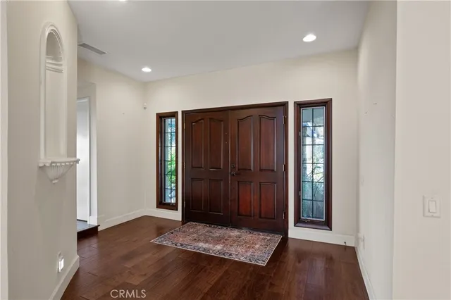 a view of an entryway with wooden floor