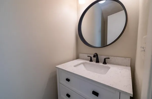 a bathroom with a sink and a mirror