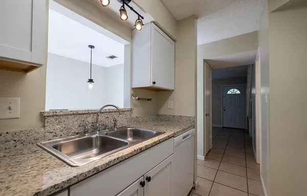 a kitchen with a sink and cabinets