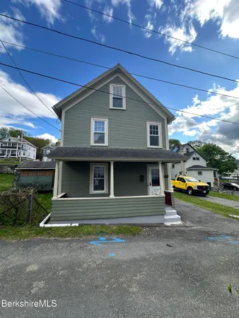 a view of front of house with outdoor seating