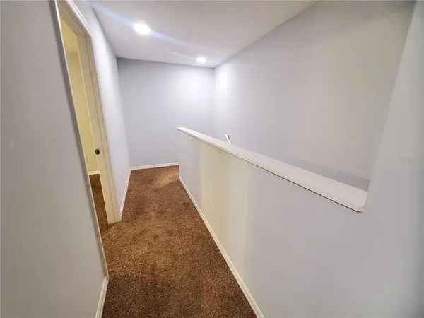 a view of a hallway with staircase