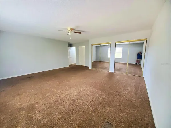 an empty room with a empty space and windows