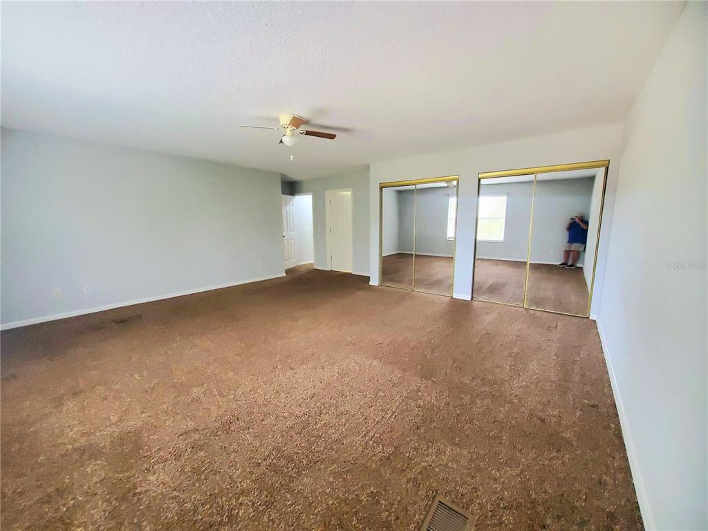 75 Atlantic Oaks Circle, Unit B St. Augustine, FL 32080 - Photo 18 of 25 an empty room with a empty space and windows