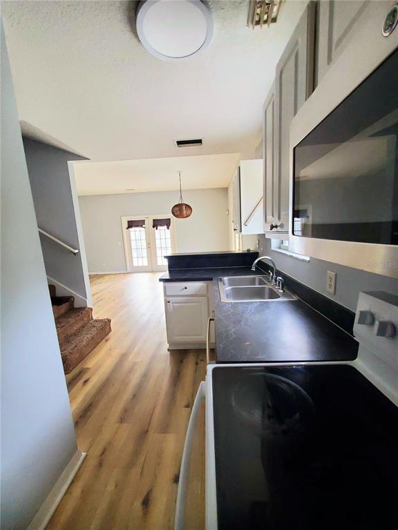 75 Atlantic Oaks Circle, Unit B St. Augustine, FL 32080 - Photo 8 of 25 a kitchen with a sink stainless steel appliances and cabinets