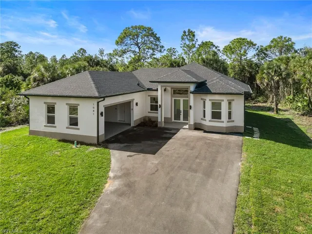 a front view of a house with a garden and a yard