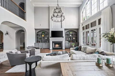 a kitchen with white cabinets and a window