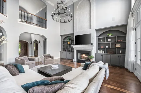 a living room with a table chairs and a fireplace