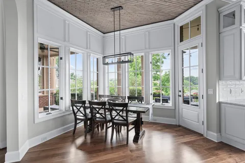 a living room with furniture floor to ceiling window and outdoor view