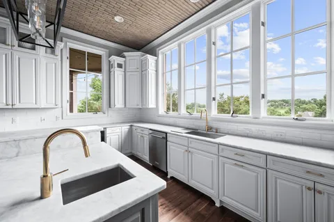 a kitchen with a stove a sink and a window