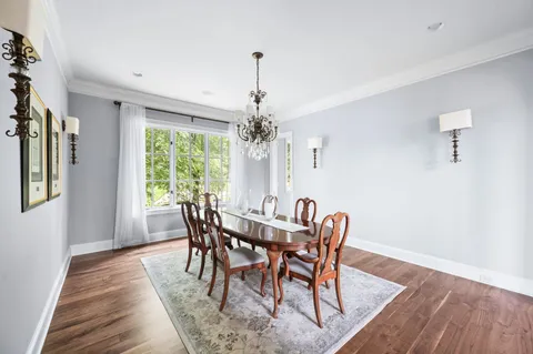 a balcony with wooden floor and outdoor seating