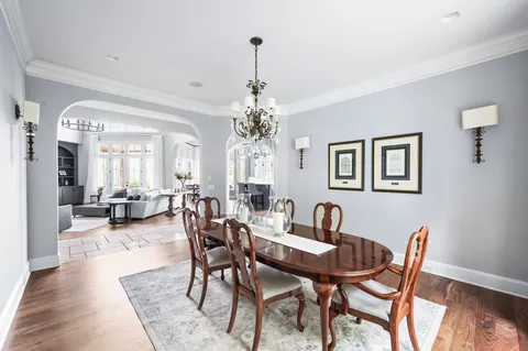 a spacious bedroom with a bed and a chandelier