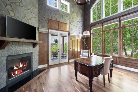 a living room with furniture pool table and ceiling fan