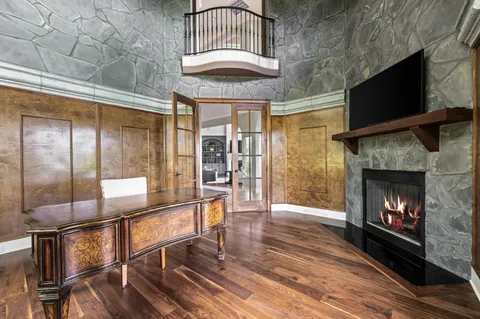 a room with pool table and windows