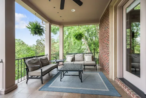 a bed sitting in a room next to a window and a chandelier