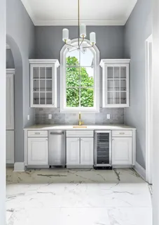 a front view of a house with a garden and plants