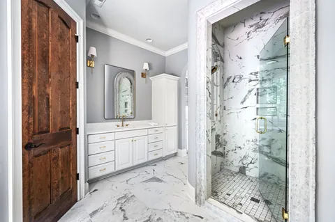 a view of a house with a small yard and a large tree