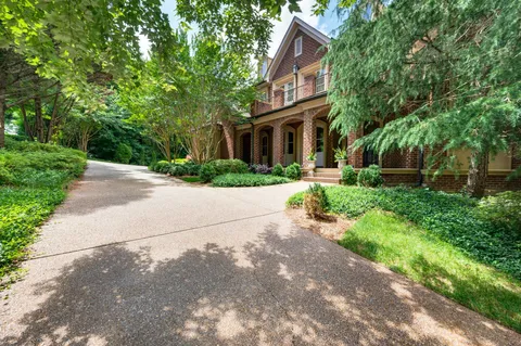 a living room with fireplace furniture and a large window
