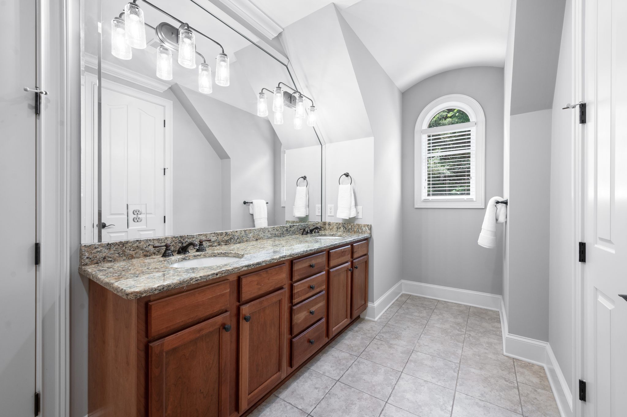 1 Wentworth Place Brentwood, TN 37027 - Photo 65 of 99 a bathroom with a granite countertop sink a mirror and a vanity