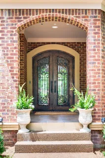 a living room with furniture a fireplace and a large window