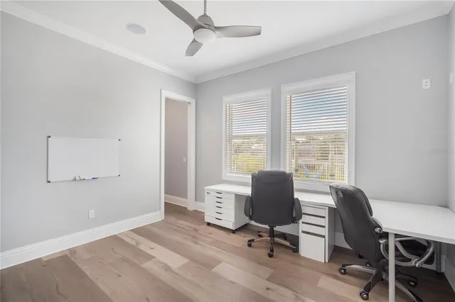 a view of a workspace with furniture and a window
