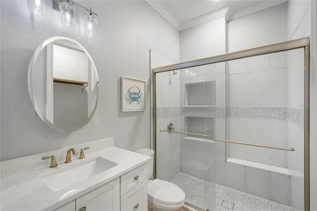 a bathroom with a toilet a sink and glass door