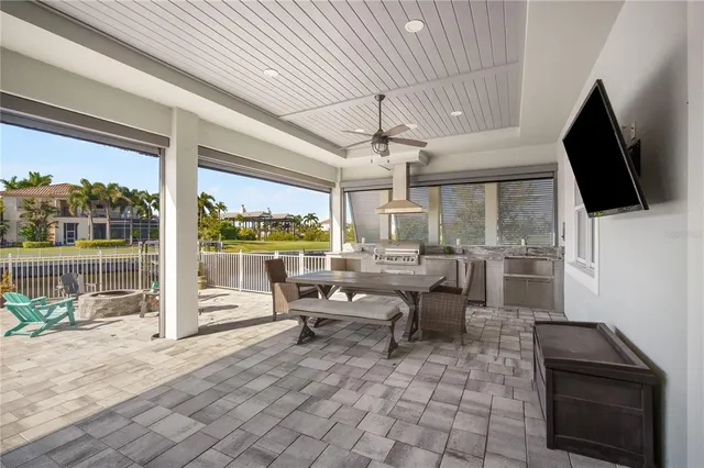 a living room with patio furniture and a flat screen tv