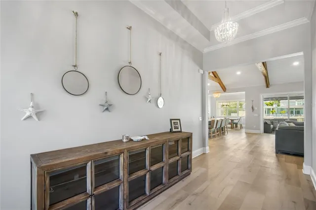 a living room with furniture a large window and wooden floor