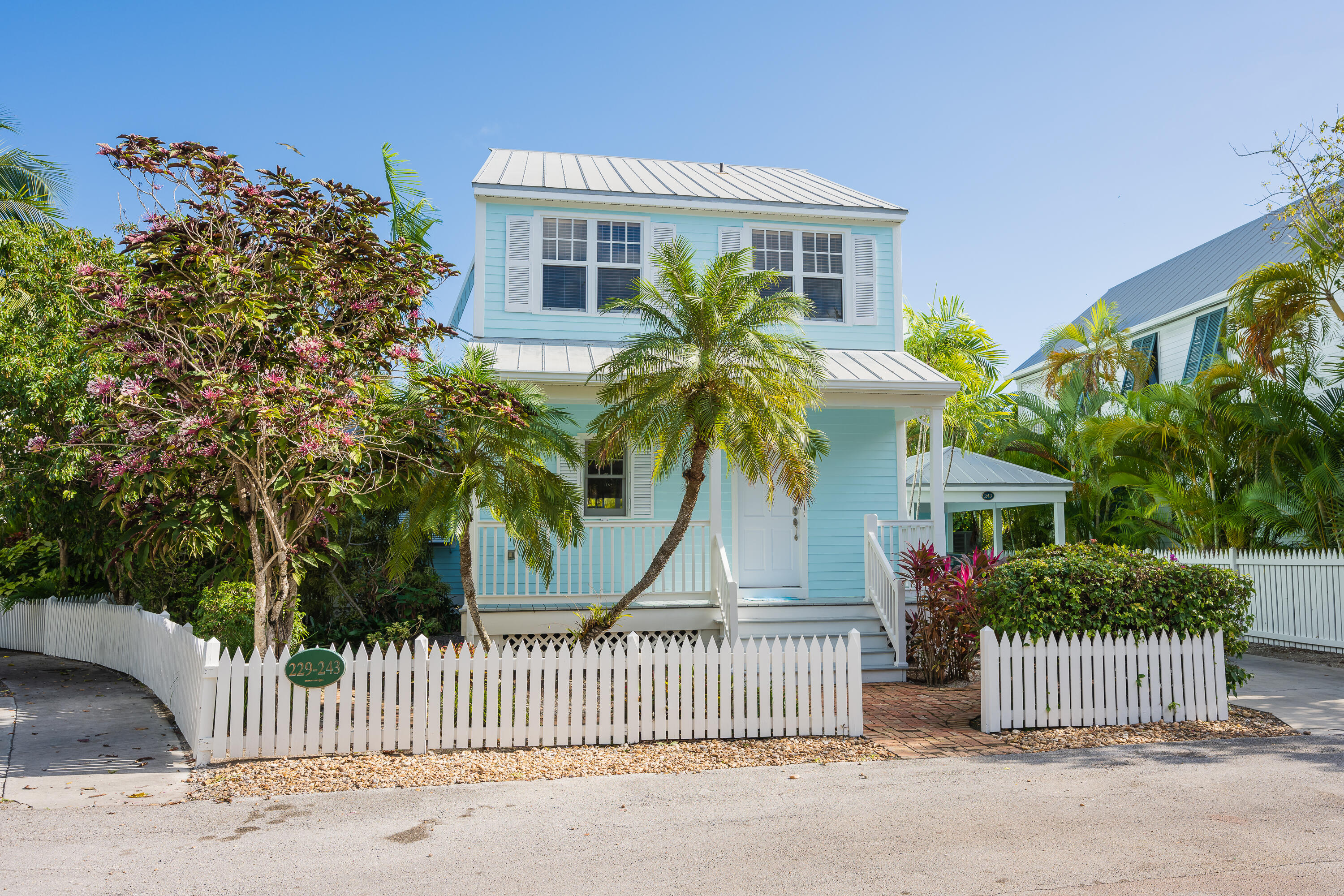 243 Golf Club Drive Key West, FL 33040 - Photo 1 of 54 a front view of a house with a garden