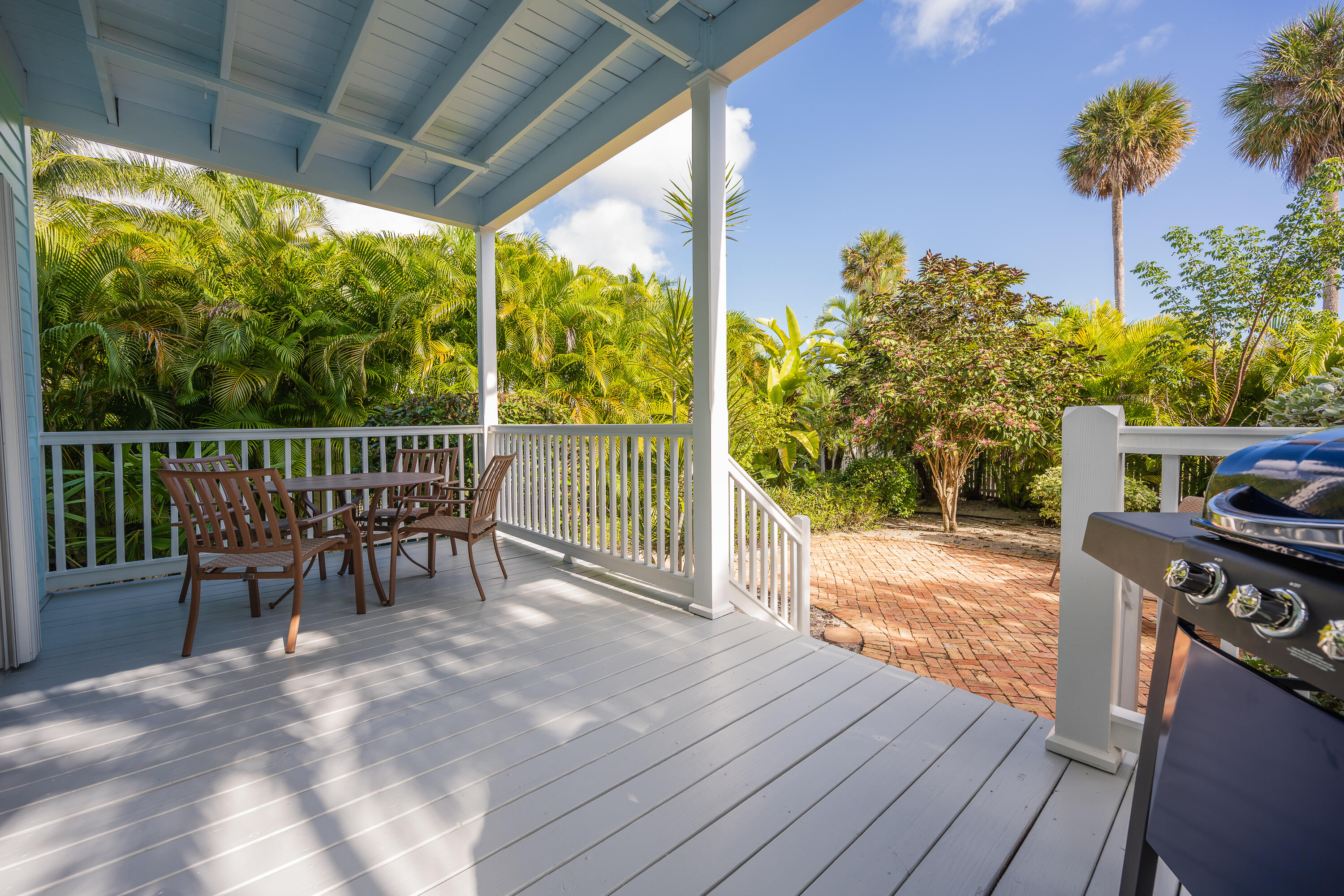 243 Golf Club Drive Key West, FL 33040 - Photo 13 of 54 a view of a roof deck with table and chairs and wooden floor