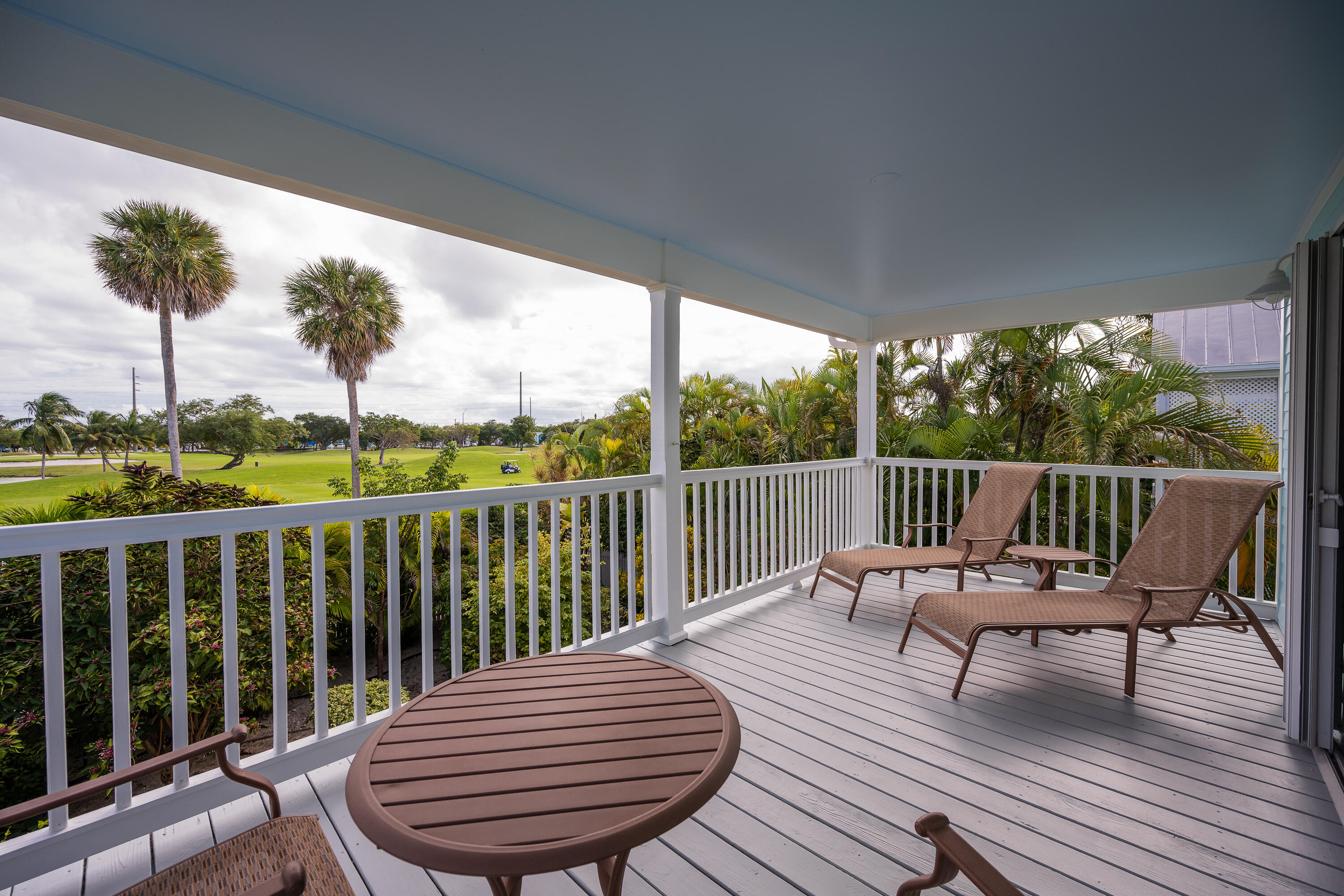 243 Golf Club Drive Key West, FL 33040 - Photo 27 of 54 a view of a chair on wooden deck