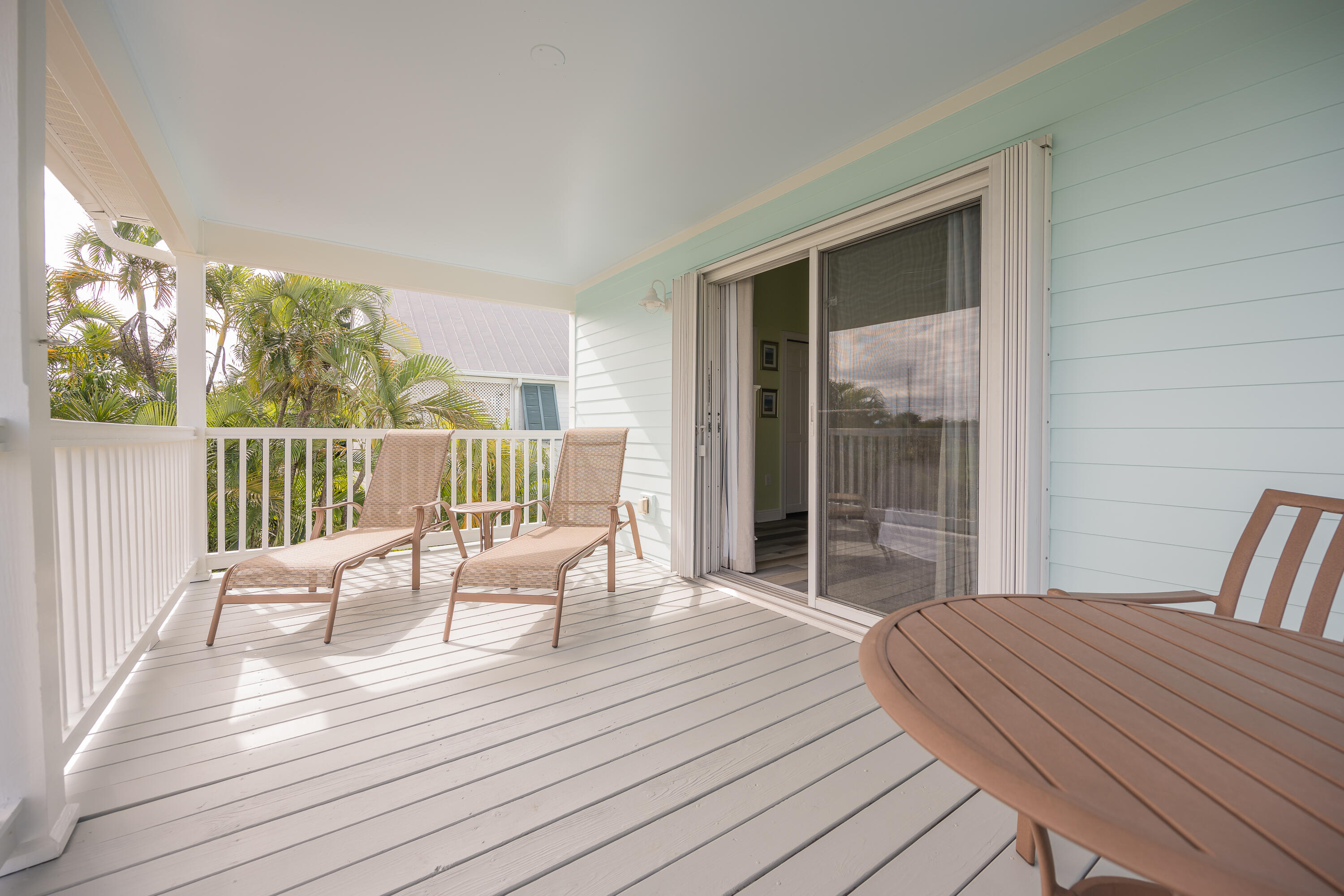 243 Golf Club Drive Key West, FL 33040 - Photo 31 of 54 a view of a deck with chair and wooden floor