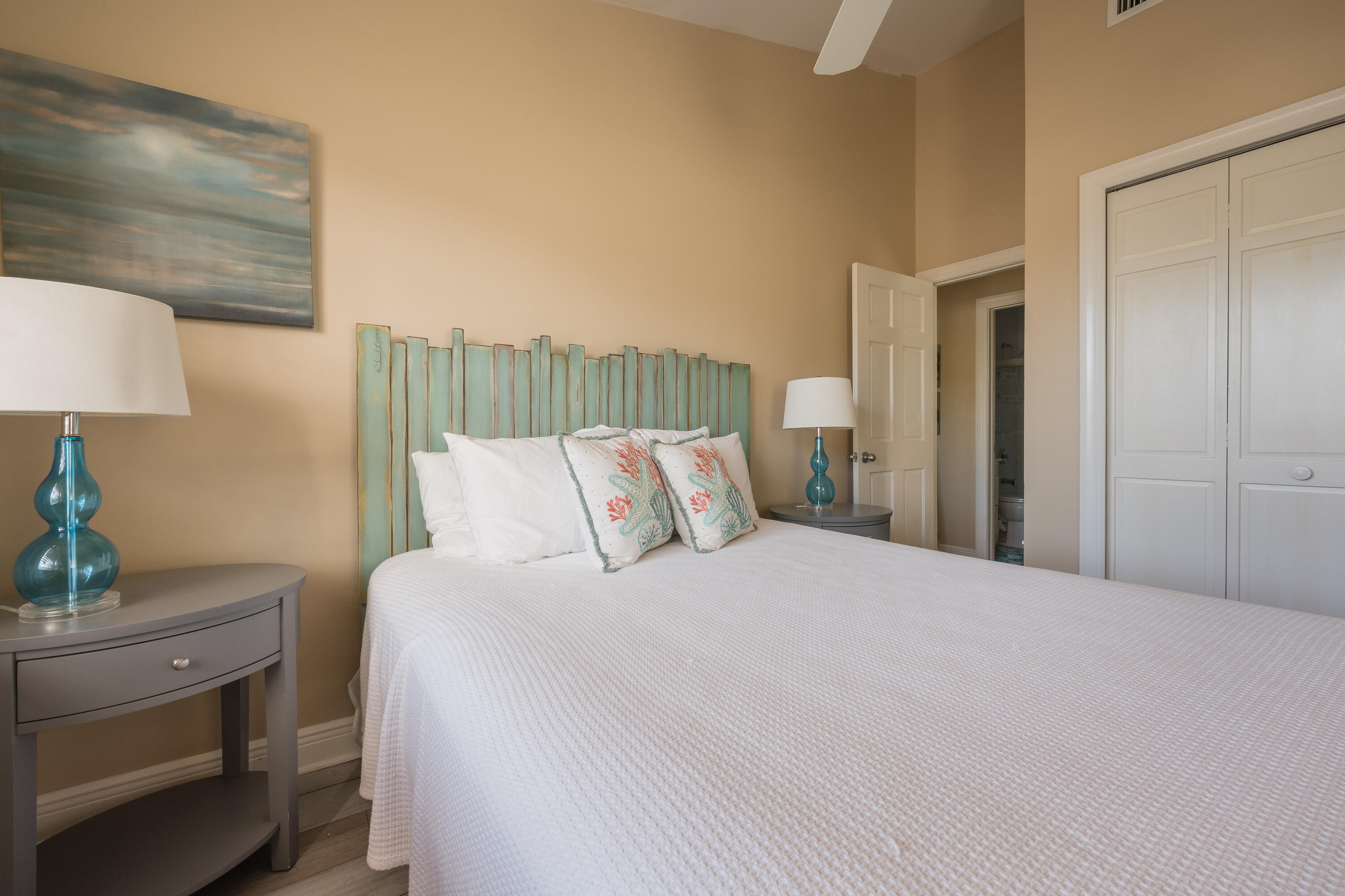 243 Golf Club Drive Key West, FL 33040 - Photo 37 of 54 a bedroom with a bed and a lamp on dresser