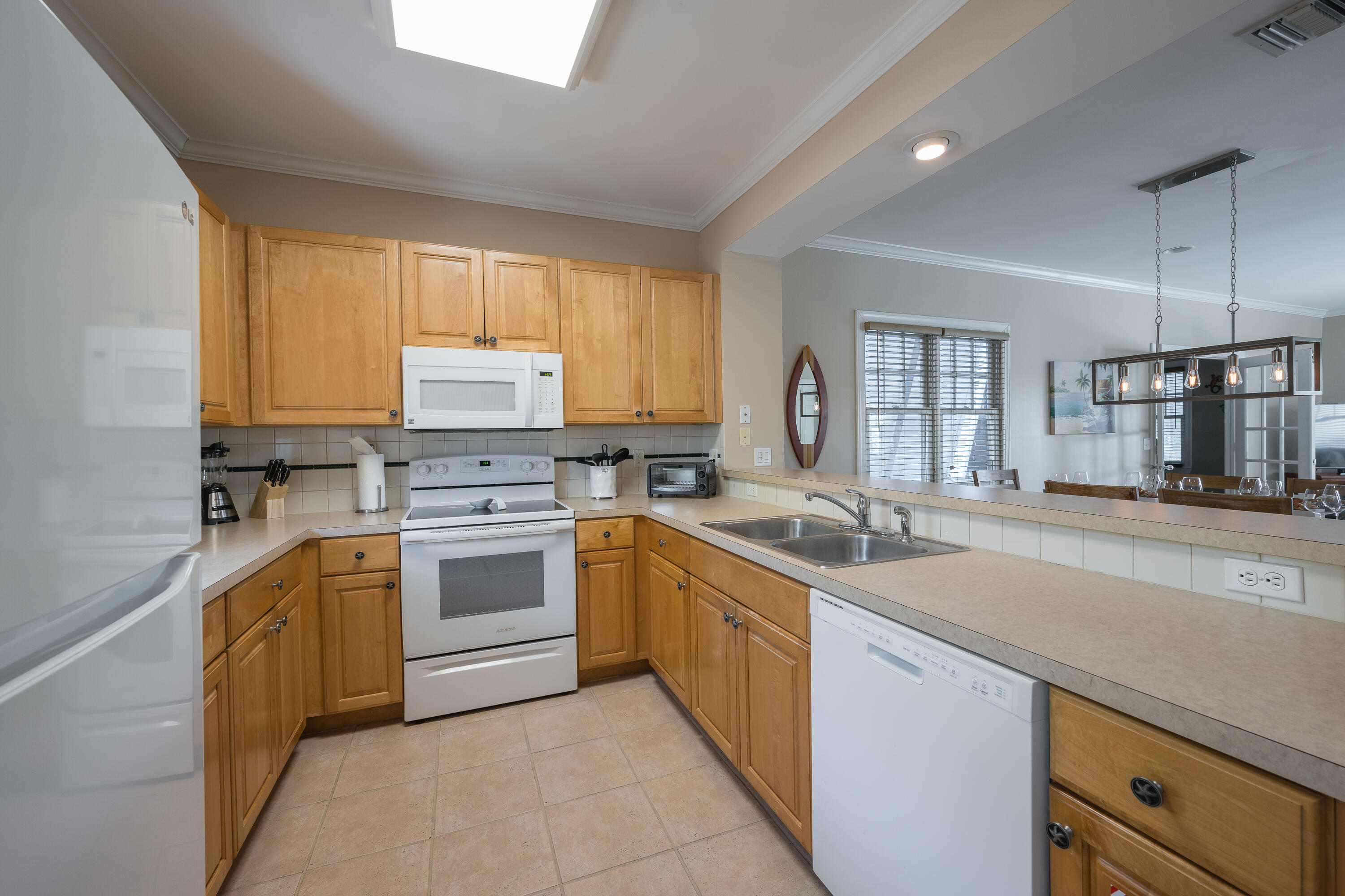 243 Golf Club Drive Key West, FL 33040 - Photo 5 of 54 a kitchen with a sink stove and cabinets