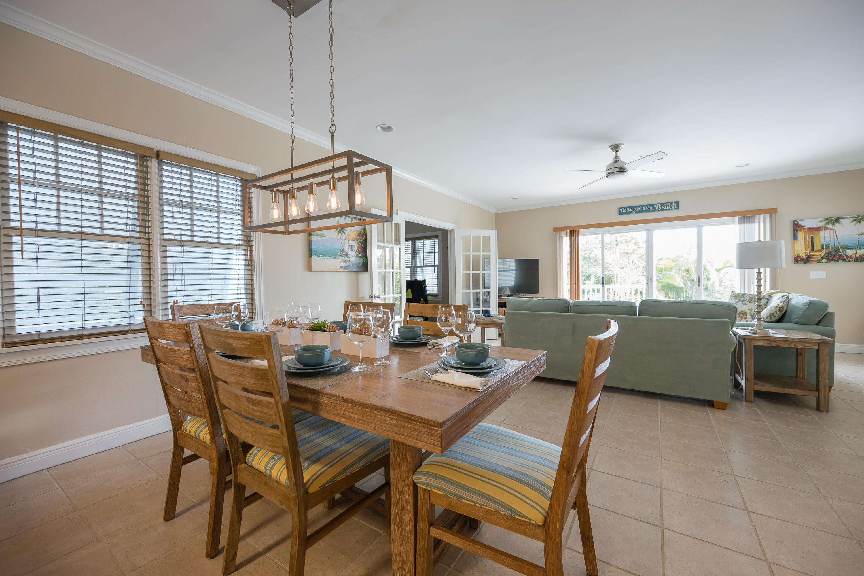 243 Golf Club Drive Key West, FL 33040 - Photo 9 of 54 a dining room with furniture a chandelier and wooden floor
