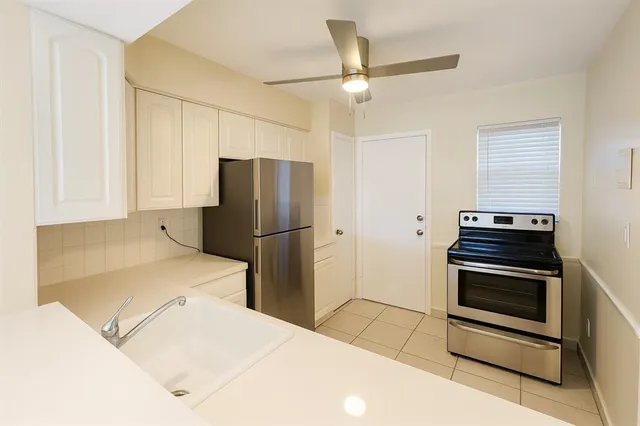 a kitchen with stainless steel appliances a stove a refrigerator and cabinets