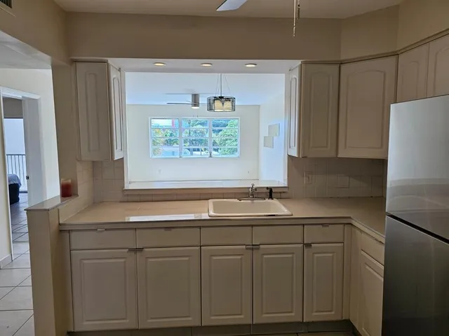 a kitchen with a sink and cabinets