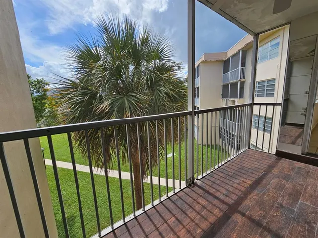 a view of balcony with wooden floor