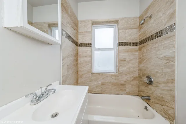 a bathroom with a tub and a sink