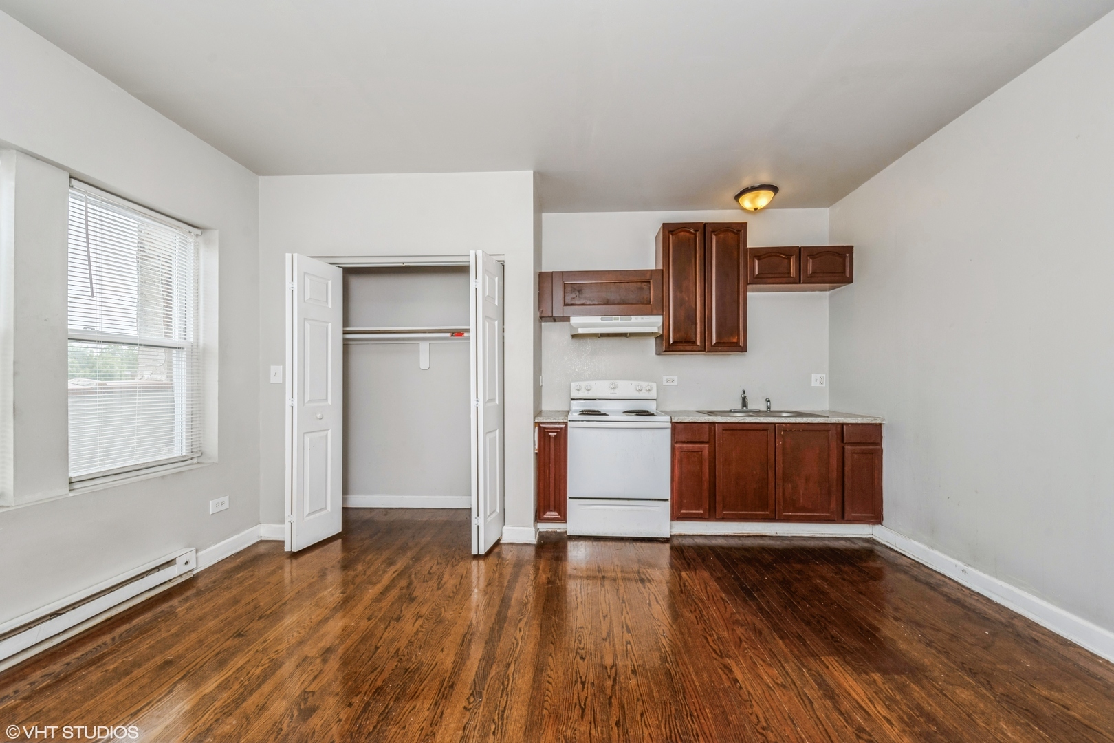1506 East 67th Street, Unit 208 Chicago, IL 60637 - Photo 7 of 7 a view of kitchen with wooden floor and electronic appliances