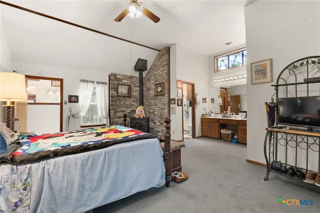 a bedroom with furniture and a flat screen tv