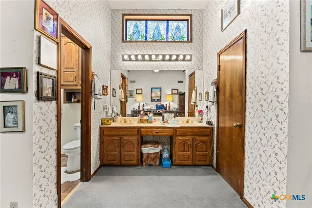 a large bathroom with a large mirror vanity and a shower